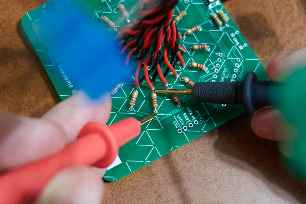 multimeter probes connected across a resistor